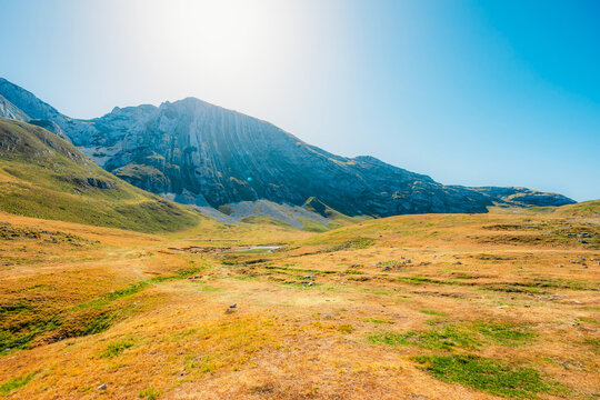 Grand panoramic view from Prutas peak at sunset, overlooking the dramatic limestone ridges and deep valleys of Durmitor National Park, Montenegro.