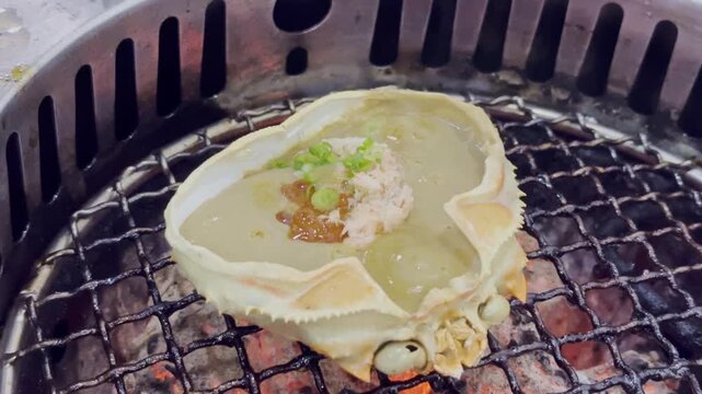 Close-up of a crab shell filled with rich and creamy crab tomalley, beautifully presented as a premium seafood delicacy in Japanese cuisine.