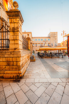 Zadar, Croatia. Old town street of Zadar with the Church of St. Donatus and the bell tower of the Cathedral of St. Anastasia at sunset.