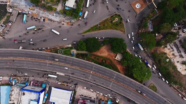 Top down shot of BHEl flyover with junction, traffic flow and bhel entrance at Lingampally, chanda nagar, hyderabad, telangana, india. day time, slight push in shot, drone shot, 4k.