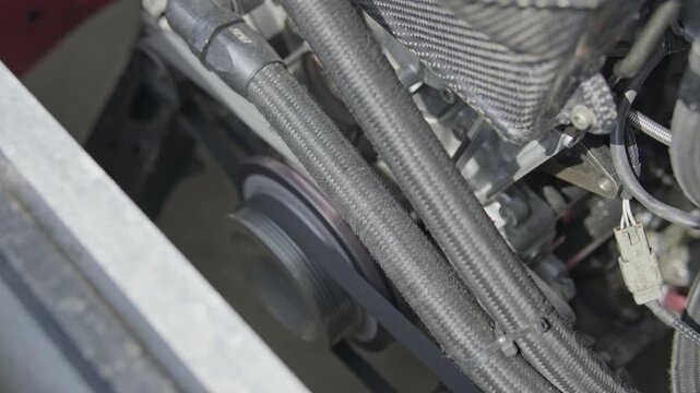 Close-up of braided fuel lines and engine components