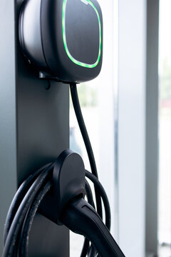 Electric vehicle charger showing green light, signifying readiness for use and supporting eco-friendly transportation solutions