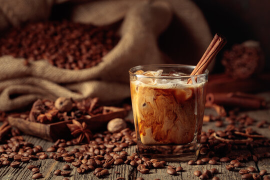 Iced coffee with cream on an old wooden table.