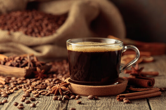 Cup of black coffee on an old wooden table.