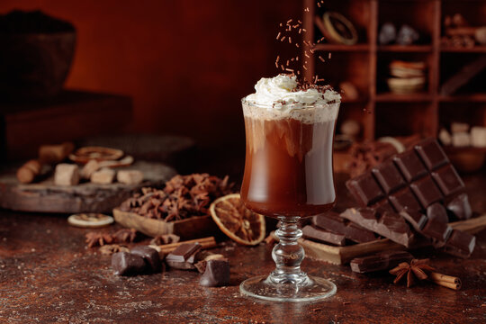 Hot chocolate topped with whipped cream and sprinkled with chocolate chips.