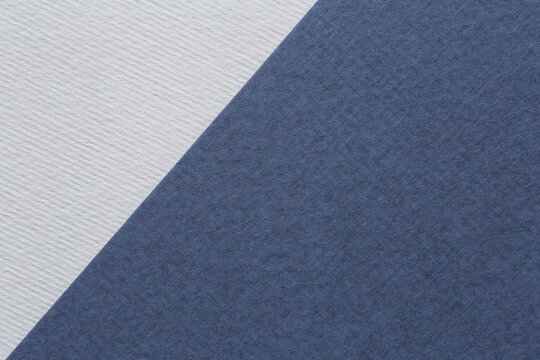 close up of white and denim color sheets of craft paper