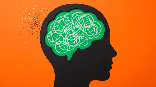 Conceptual image of a human head silhouette with a scribbled brain inside, representing mental health, stress, anxiety, or complex thinking