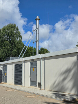 Modern Utility Building with Lightning Protection and Technical Infrastructure Under a Blue Sky