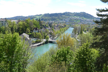 Fototapeta premium Elevated view of the Aare River winding through green Bern Switzerland