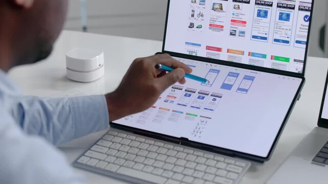 App Developer Carefully Designs User Interface On Laptop
