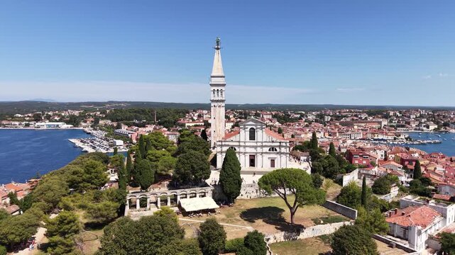 Flight over hilltop Church of St Euphemia landmark in Rovinj city, Croatia