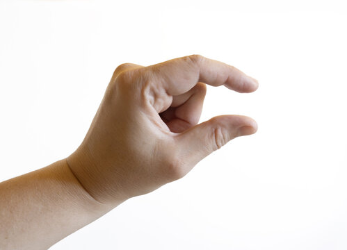 Close-up of a human hand against a white background with thumb and index finger forming a small gap, symbolizing measurement, precision, or indicating something small.