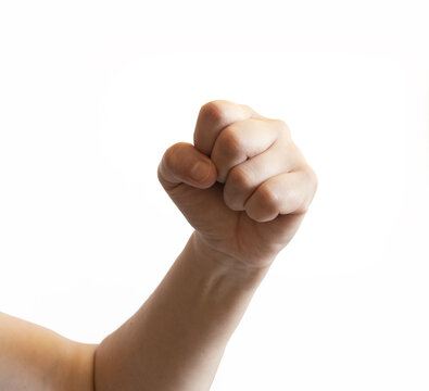 Human hand forming a raised closed fist on a white background. The gesture shows strength, confidence, or determination.