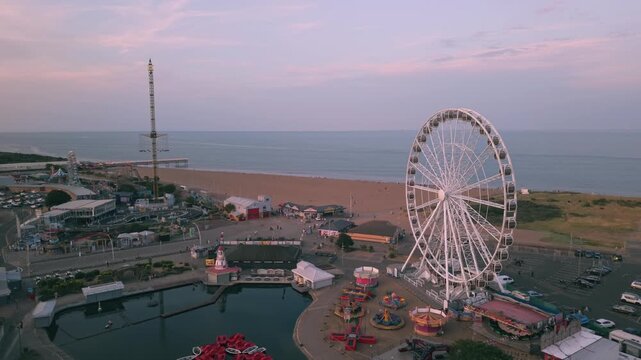 Coastal sunset seaside holiday resort of Skegness on the east coast of Lincolnshire UK, English vacation and sweeping vista views. Evening nightlife with Big Wheel rides and amusements. Pier and town
