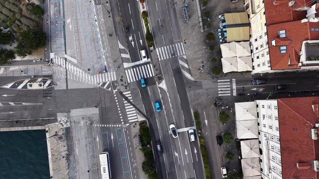 Top down view of pedestrian crosswalk and street traffic in Trieste city, Italy
