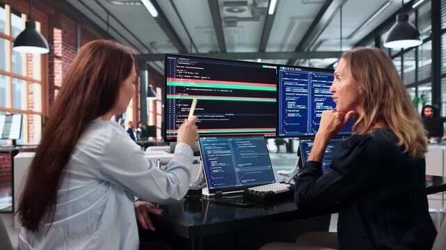 Young Woman Merges Code Changes On Laptop
