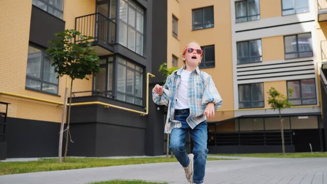 Fashionable Child Dancing In Contemporary Urban Courtyard