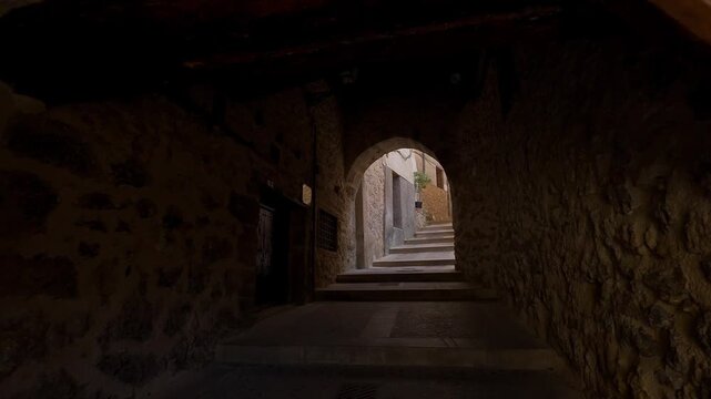 Covered stone passage with wooden beams and steps in the historic old town of Cuenca Spain