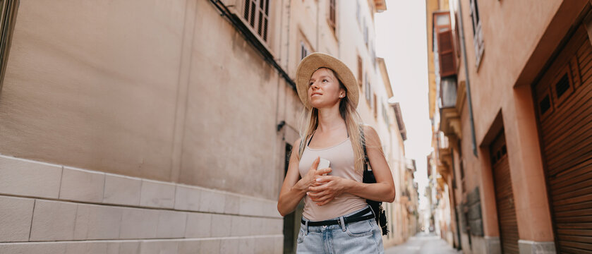Young Female Tourist with Backpack and Smartphone Enjoying Panoramic View of Rome