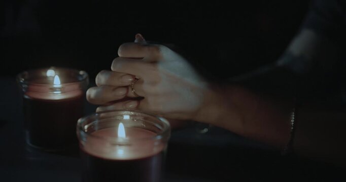 fortune teller hands and candles at night