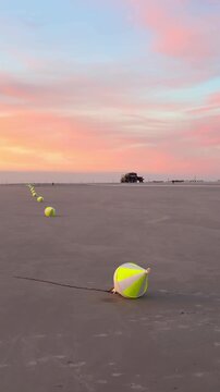 buoys on the sand beach in sunset 