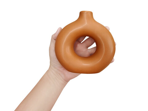 A modern-style brown vase is in a man's hands PNG transparent.