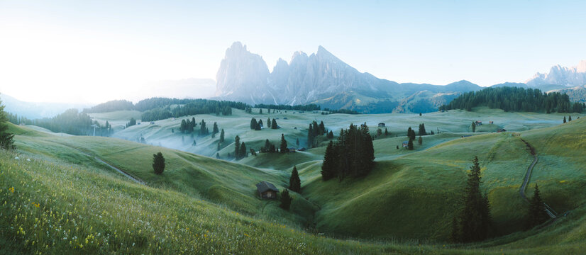 Scenic alpine landscape with mountain huts in the Alps at sunrise in summer