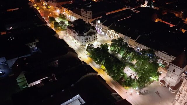 Night aerial footage of the historic center of Kosice, Slovakia, showing St. Elisabeth Cathedral, the Urban Tower and the city&rsquo;s main square. The drone view highlights the illuminated Gothic landmark 