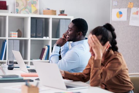 Annoying colleague talking loudly distracting frustrated woman at work