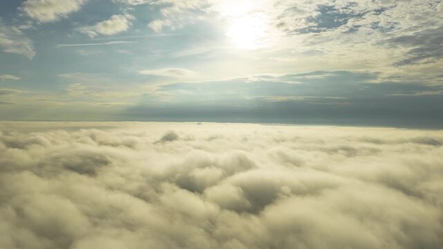 White clouds and sunshine high in the sky