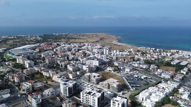 Aerial view of Paphos city skyline extending towards the historic Tombs of the Kings coastal area, Cyprus