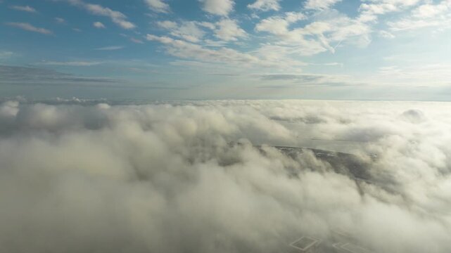 White clouds and sunshine high in the sky