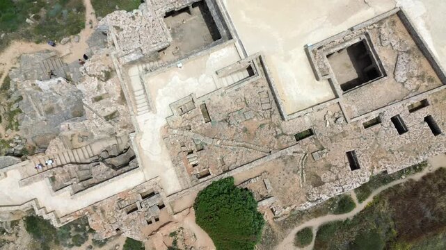 Top down drone view of open atrium and underground tombs at Tombs of the Kings, Cyprus