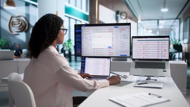 IT Support Specialist Carefully Manages Helpdesk Tickets Using Laptop