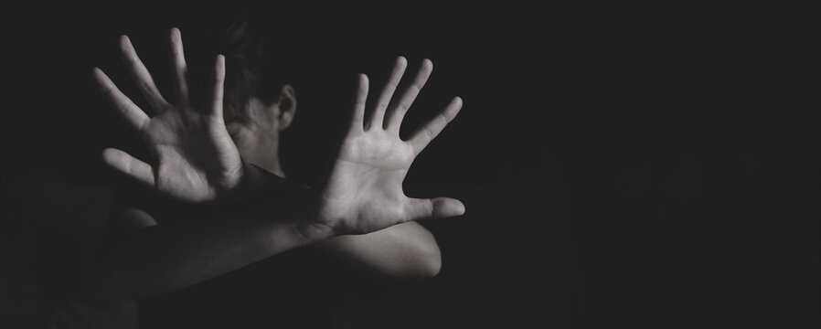 Woman holding up her palm as a symbol of resistance and protection. Concept of women rights, victim support, human trafficking awareness, safety, and freedom.