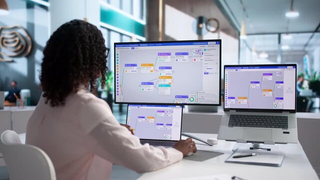 Business Analyst Optimizes Workflow Using Laptop