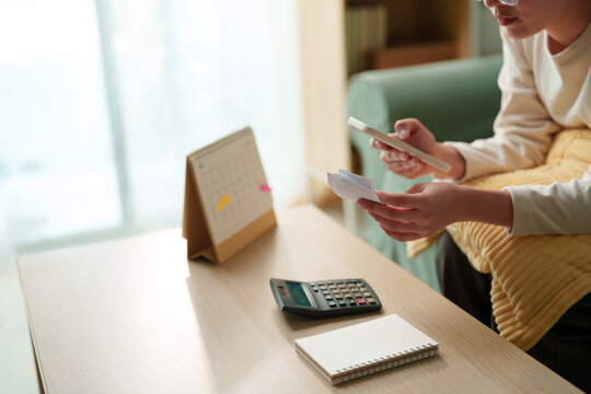 Personal finance concept featuring smartphone, receipt, calculator, notebook, calendar. Suitable budget planning, monthly expenses, bill payment, digital banking, household finance, money management
