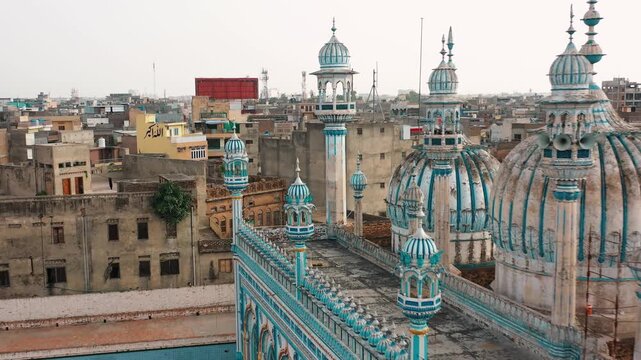 Revealing shot of Jamia Masjid Aerial Drone View of Jamia Masjid Domes with Urban Cityscape in Pakistan