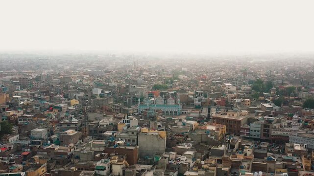 Aerial Drone Zoom In Toward Jamia Masjid in Dense Urban Cityscape of Pakistan
