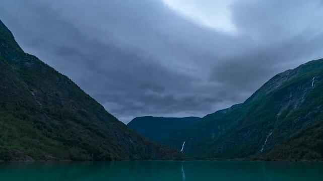 Cinematic timelapse of dramatic clouds over Eidsvatnet Lake near Sognefjord with Norwegian mountains and waterfalls