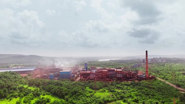 Iron plant encircled by thick woodland highlighting industrial encroachment on forest