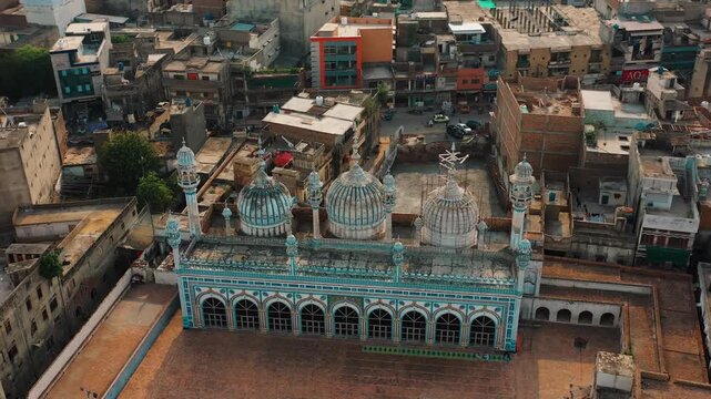 Drone Close Up of Historic Jamia Masjid Against Pakistan City Skyline