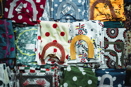 Traditional colorful Arabic clothing displayed at local market
