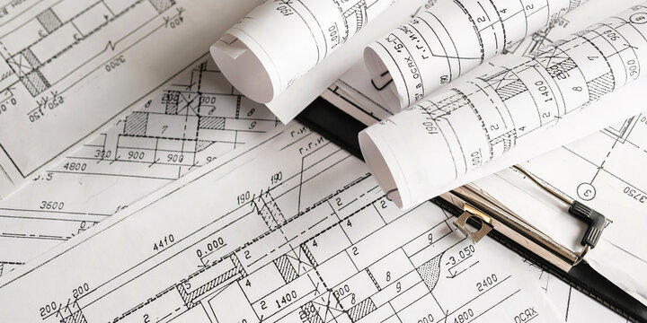 Blueprints, rolled plans and drafting tools on desk, architectural engineering workflow concept for construction planning, technical documentation, project management and building design.