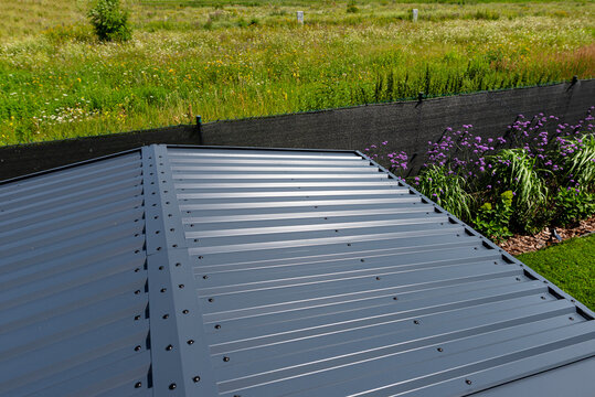 Modern corrugated sheet metal roof with screws and washers