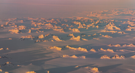 Golden light across Greenland ice fields and nunataks © Thomas