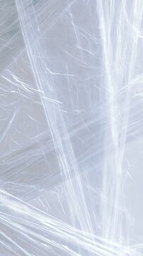 Transparent stretch film texture with multiple wrinkles and folds, high-key background, textured