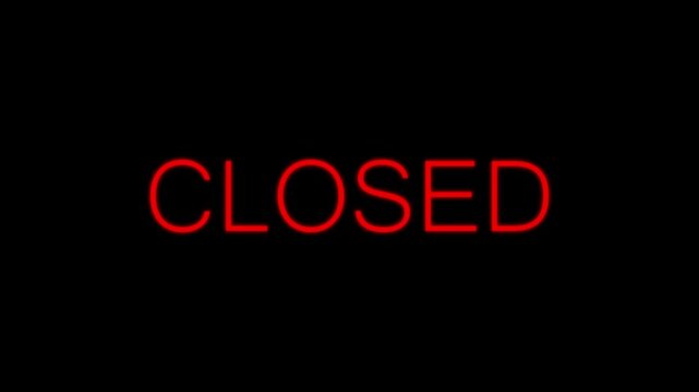 A glowing business closed sign shines brightly against a dark backdrop. This business closed sign informs customers of seasonal holiday hours. Add this business closed sign loop to corporate videos.