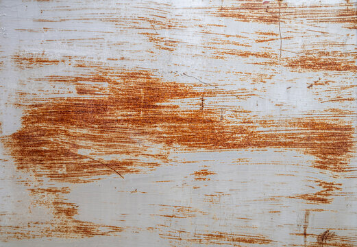 Rusted Weathered Metal Sheet Surface Texture with Brown Rust Marks and Scrapes.