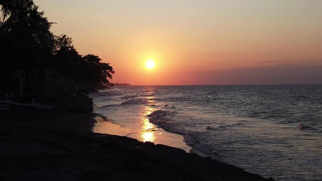 Beach at sunset on the north coast of Bali, Indonesia. Slow motion video of the beach at sunset, Bali, Indonesia, Southeast Asia.